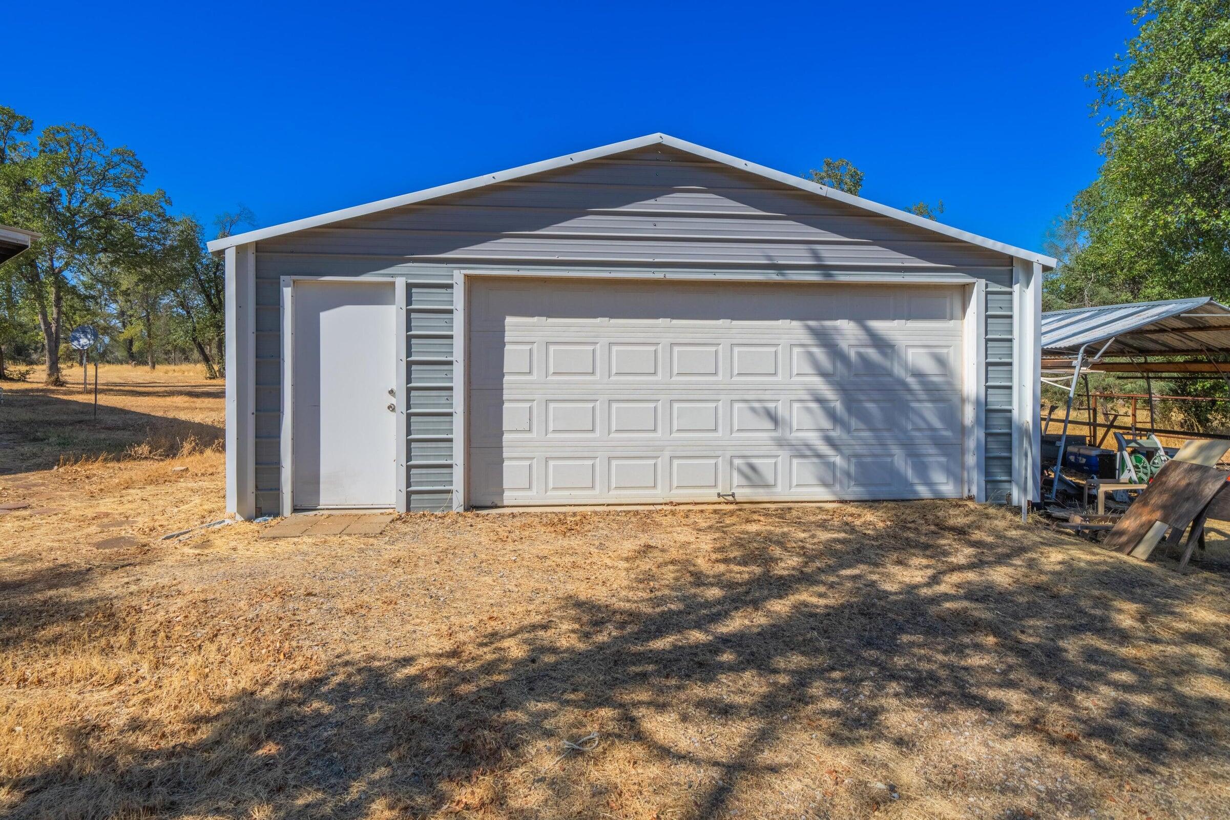 17594 Oly Way Anderson, CA 96007 - Photo 2 of 29 a front view of a house with a yard and garage