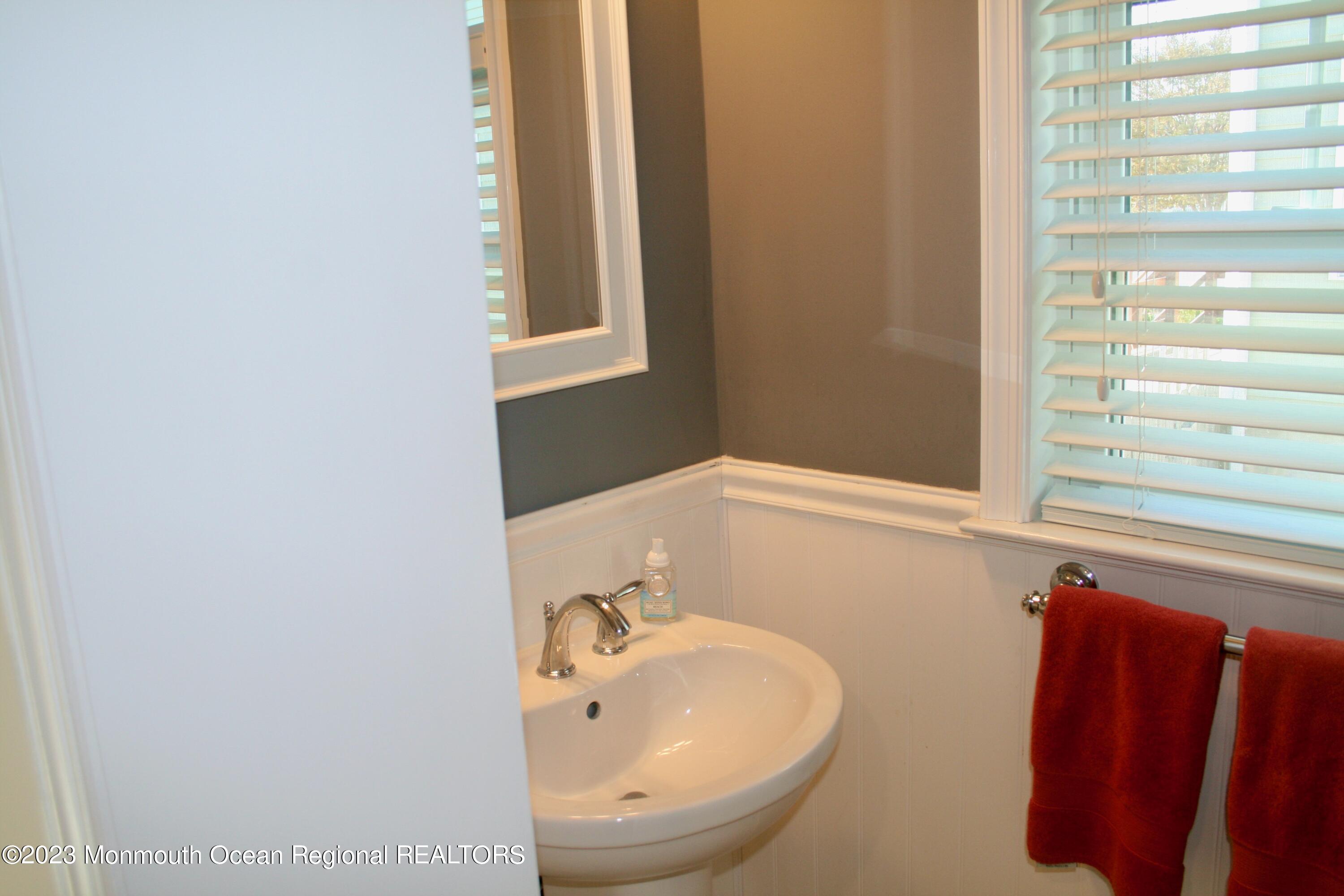 22 Pershing Boulevard Lavallette, NJ 08735 - Photo 17 of 32 a bathroom with a sink and a mirror