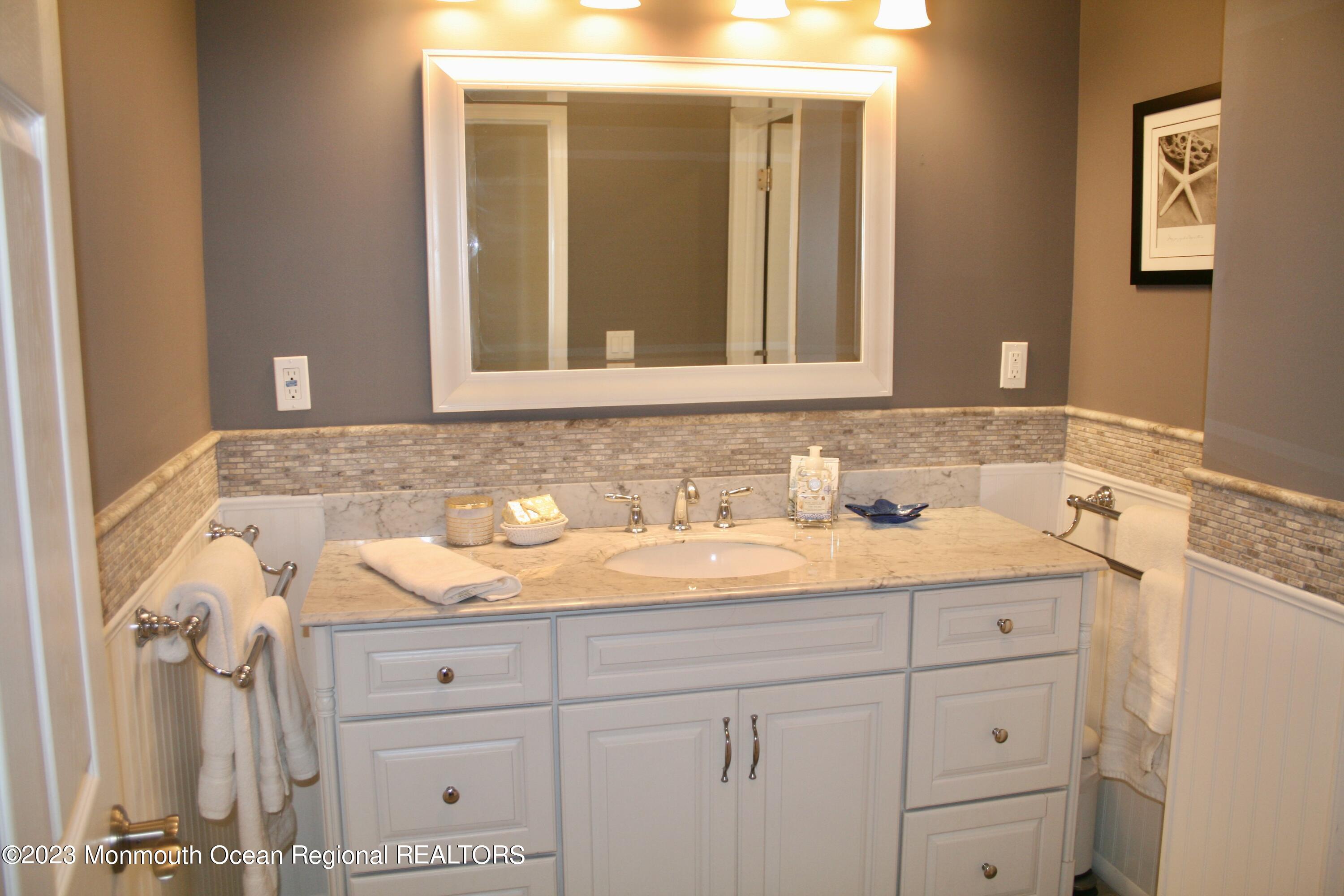 22 Pershing Boulevard Lavallette, NJ 08735 - Photo 20 of 32 a bathroom with a sink and a mirror