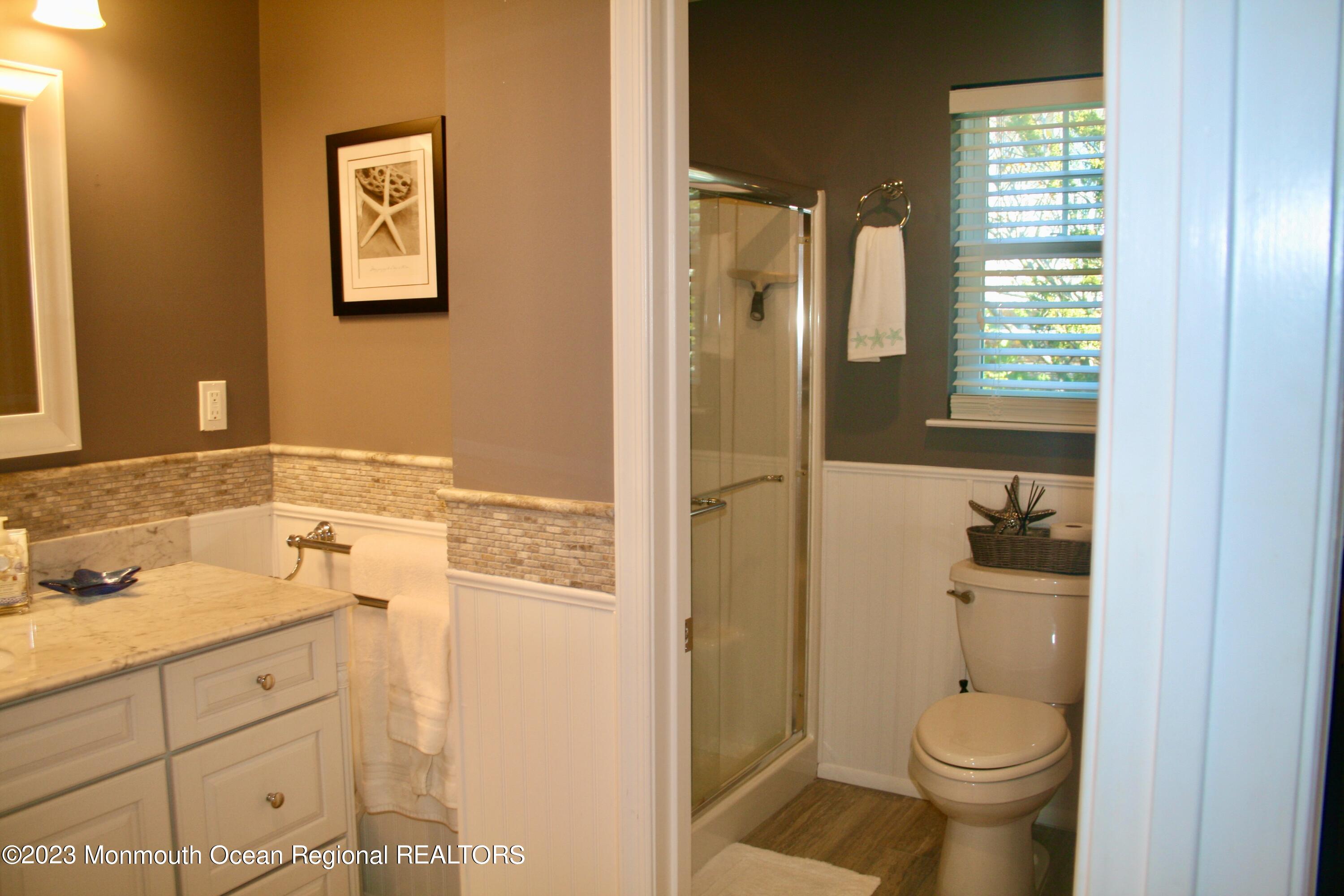 22 Pershing Boulevard Lavallette, NJ 08735 - Photo 21 of 32 a bathroom with a granite countertop toilet sink and shower