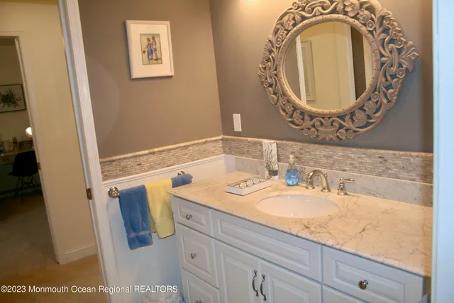 a view of a house with a wooden deck and a yard