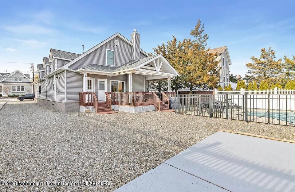 22 Pershing Boulevard Lavallette, NJ 08735 - Photo 29 of 32 a view of a house with a wooden deck and a yard