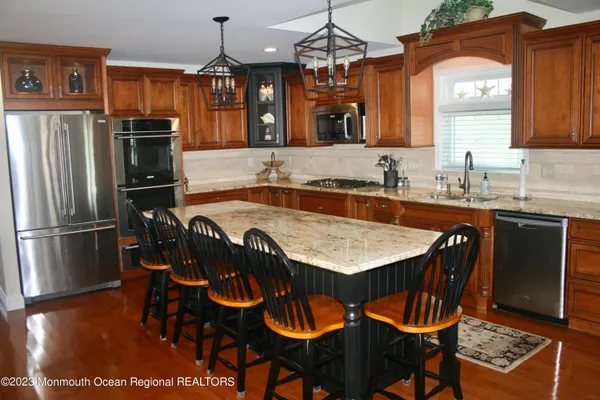 a kitchen with metallic refrigerator and cabinets