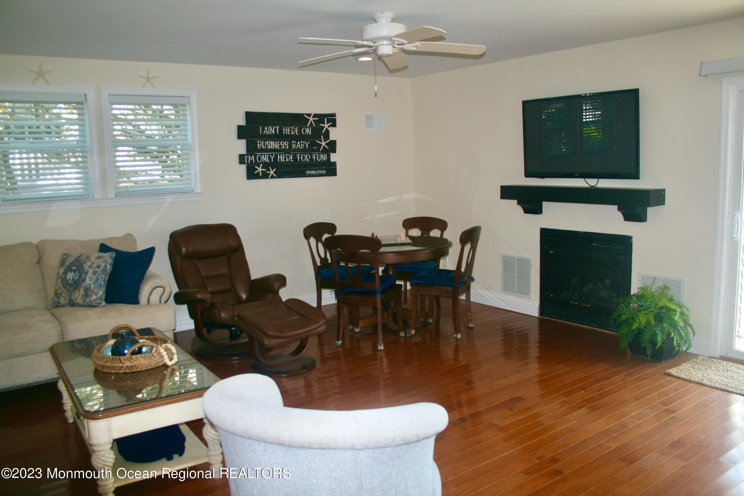 22 Pershing Boulevard Lavallette, NJ 08735 - Photo 10 of 32 a living room with furniture a fireplace and a flat screen tv