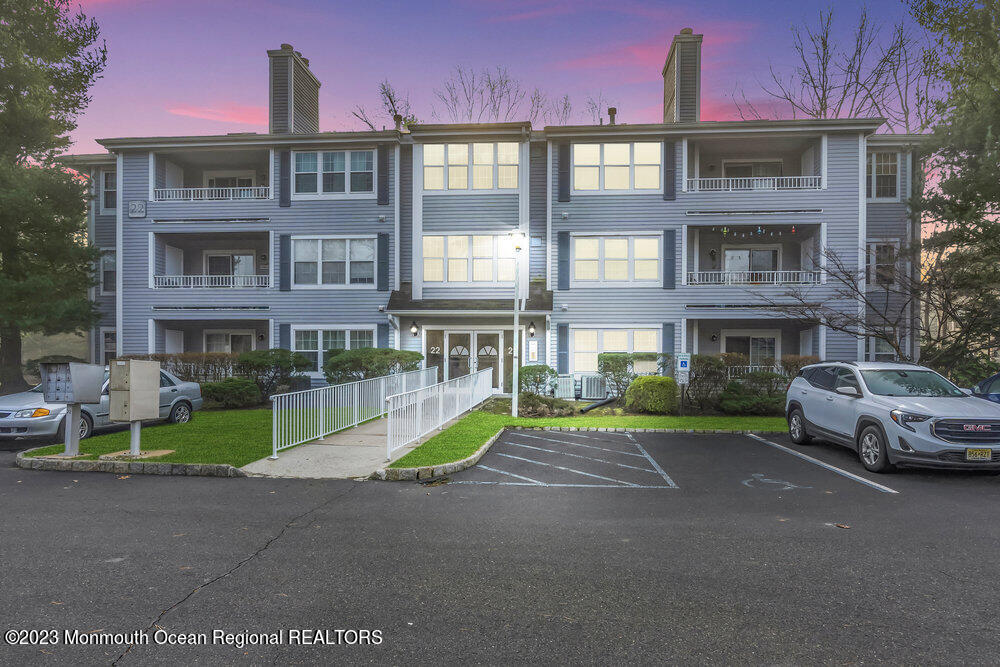 2206 Candlelight Court, Unit 2206 Helmetta, NJ 08828 - Photo 1 of 38 a yellow building with a yard in front of it