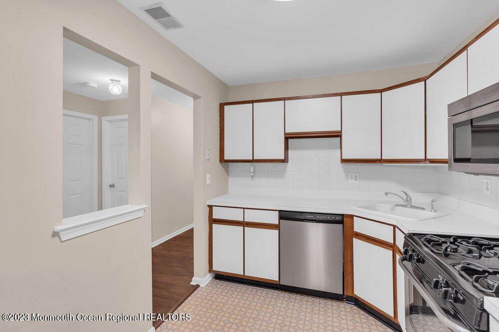 2206 Candlelight Court, Unit 2206 Helmetta, NJ 08828 - Photo 12 of 38 a kitchen with stainless steel appliances granite countertop a stove and a sink