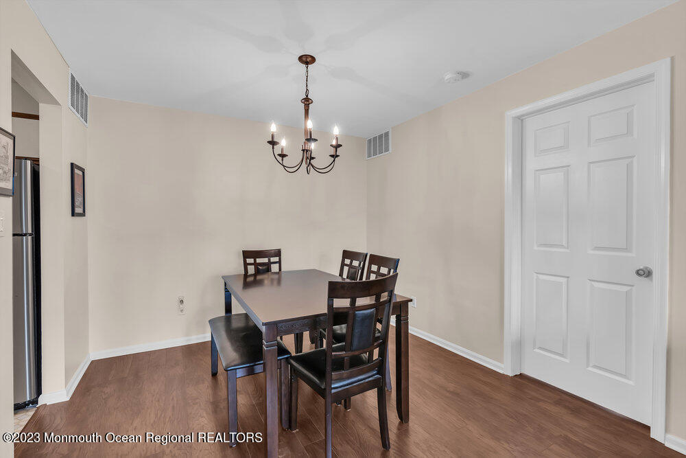 2206 Candlelight Court, Unit 2206 Helmetta, NJ 08828 - Photo 15 of 38 a view of a dining room with furniture and wooden floor
