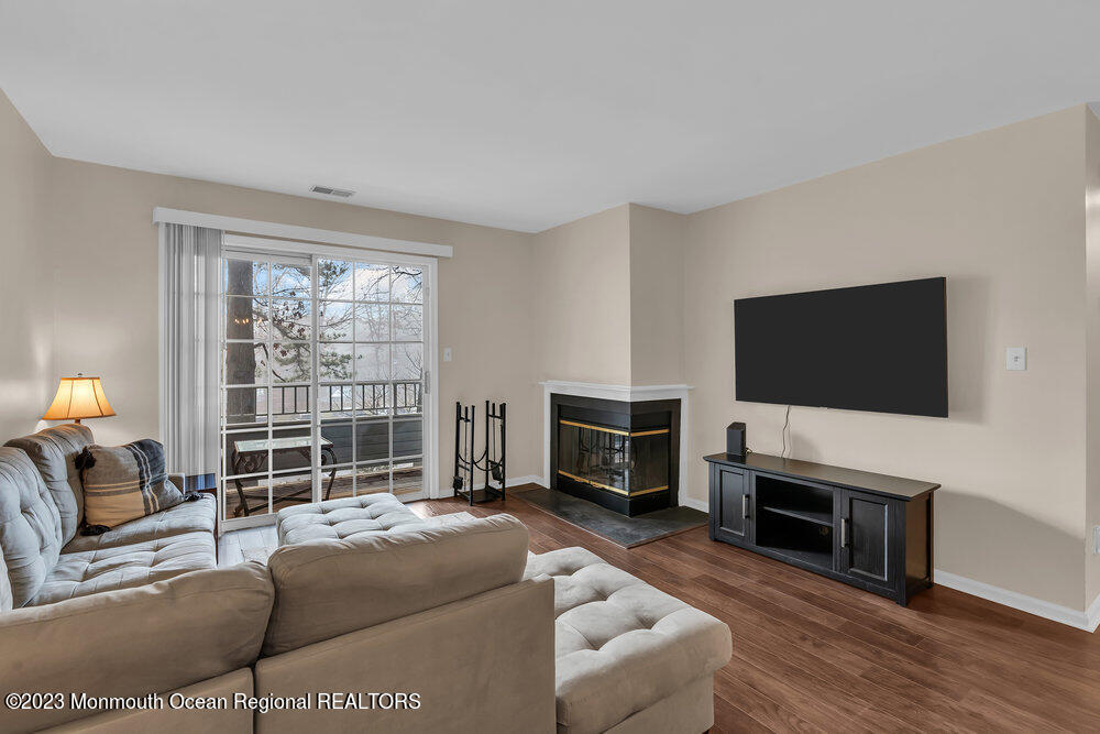 2206 Candlelight Court, Unit 2206 Helmetta, NJ 08828 - Photo 21 of 38 a living room with furniture a flat screen tv and a fireplace