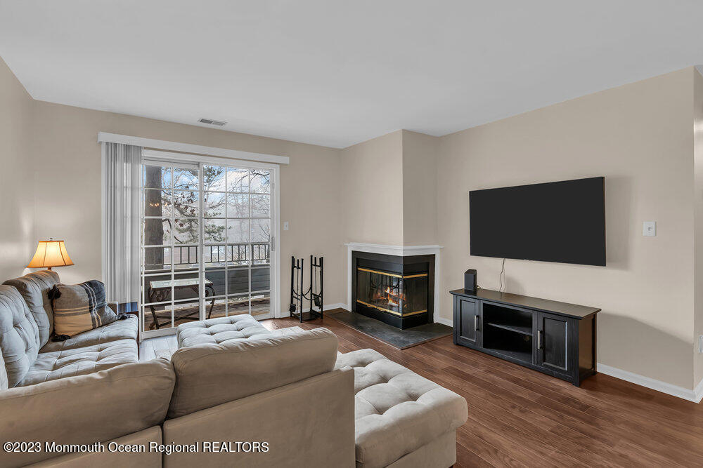 2206 Candlelight Court, Unit 2206 Helmetta, NJ 08828 - Photo 22 of 38 a living room with furniture a flat screen tv and a fireplace