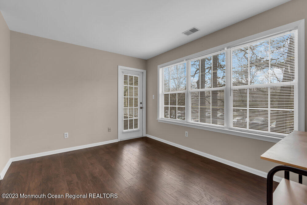 2206 Candlelight Court, Unit 2206 Helmetta, NJ 08828 - Photo 28 of 38 a view of an empty room with wooden floor and a window