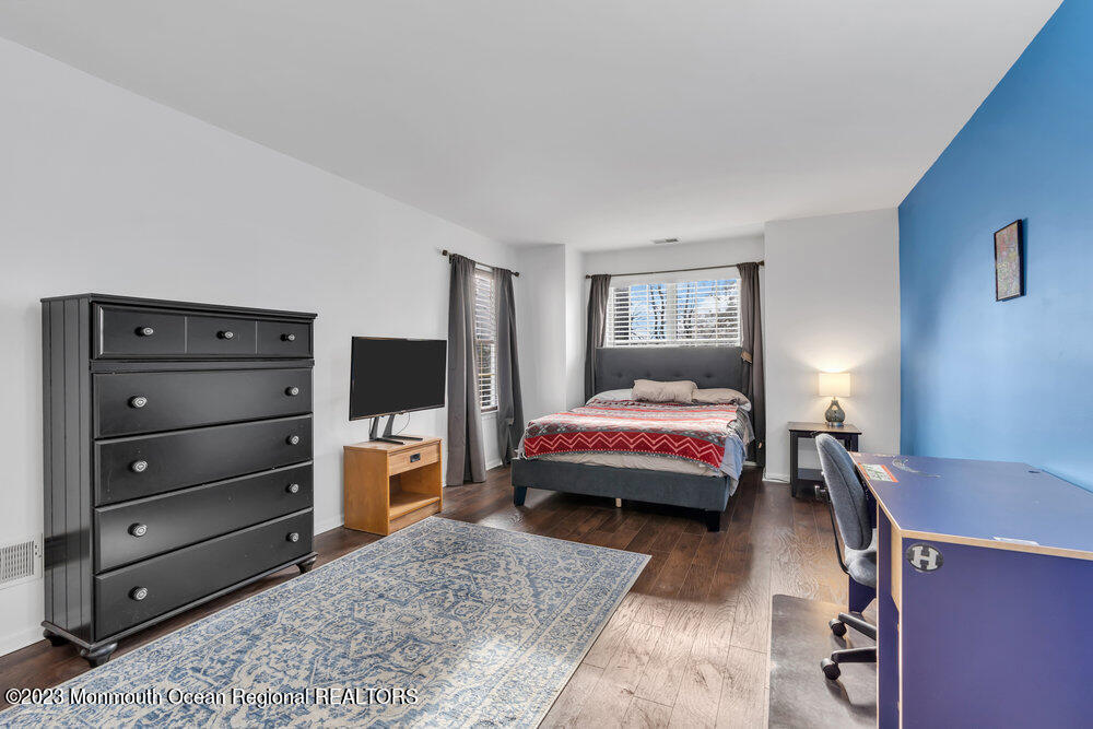 2206 Candlelight Court, Unit 2206 Helmetta, NJ 08828 - Photo 31 of 38 a bedroom with a bed and a flat screen tv