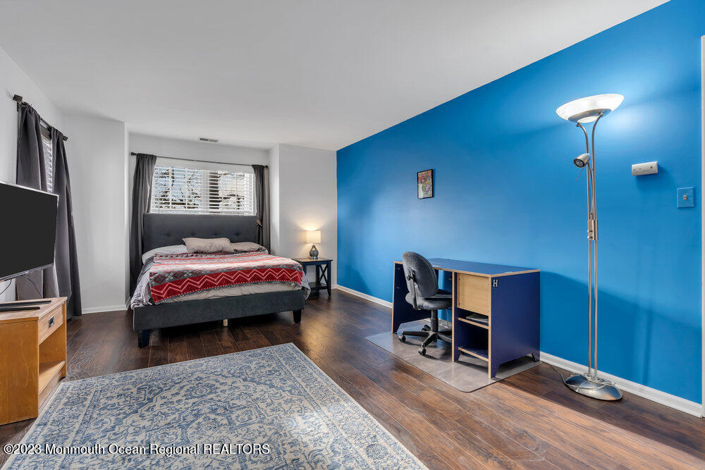 2206 Candlelight Court, Unit 2206 Helmetta, NJ 08828 - Photo 32 of 38 a bedroom with a bed and a flat screen tv