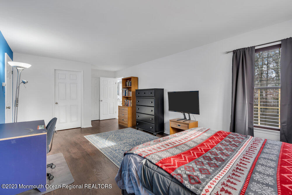 2206 Candlelight Court, Unit 2206 Helmetta, NJ 08828 - Photo 33 of 38 a bedroom with a bed and a dresser
