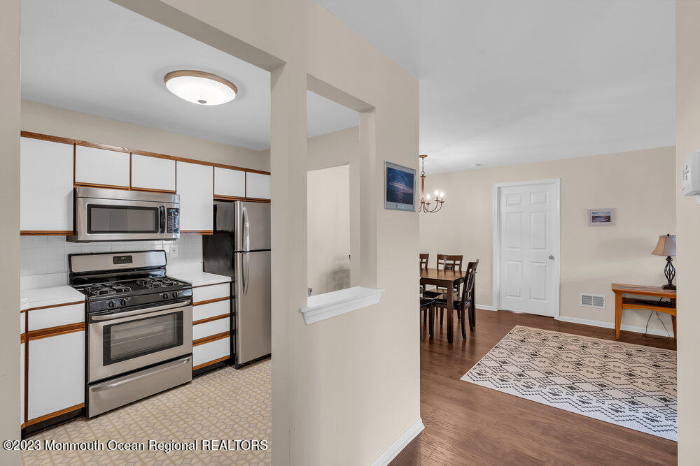 2206 Candlelight Court, Unit 2206 Helmetta, NJ 08828 - Photo 10 of 38 a kitchen with stainless steel appliances granite countertop a refrigerator and a stove top oven