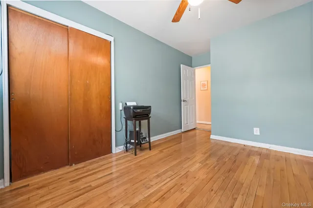 a view of room with window and wooden floor