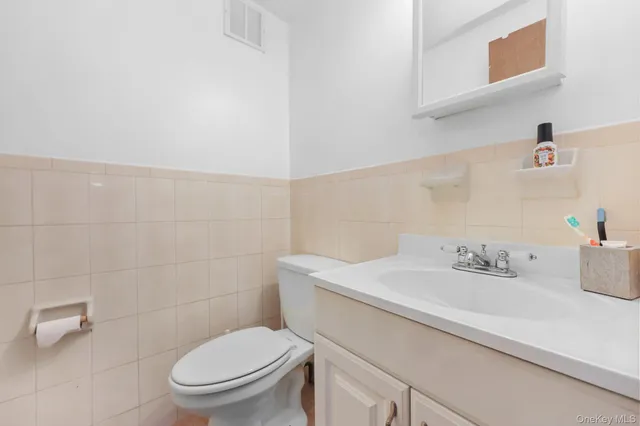 a bathroom with a sink a toilet and a mirror