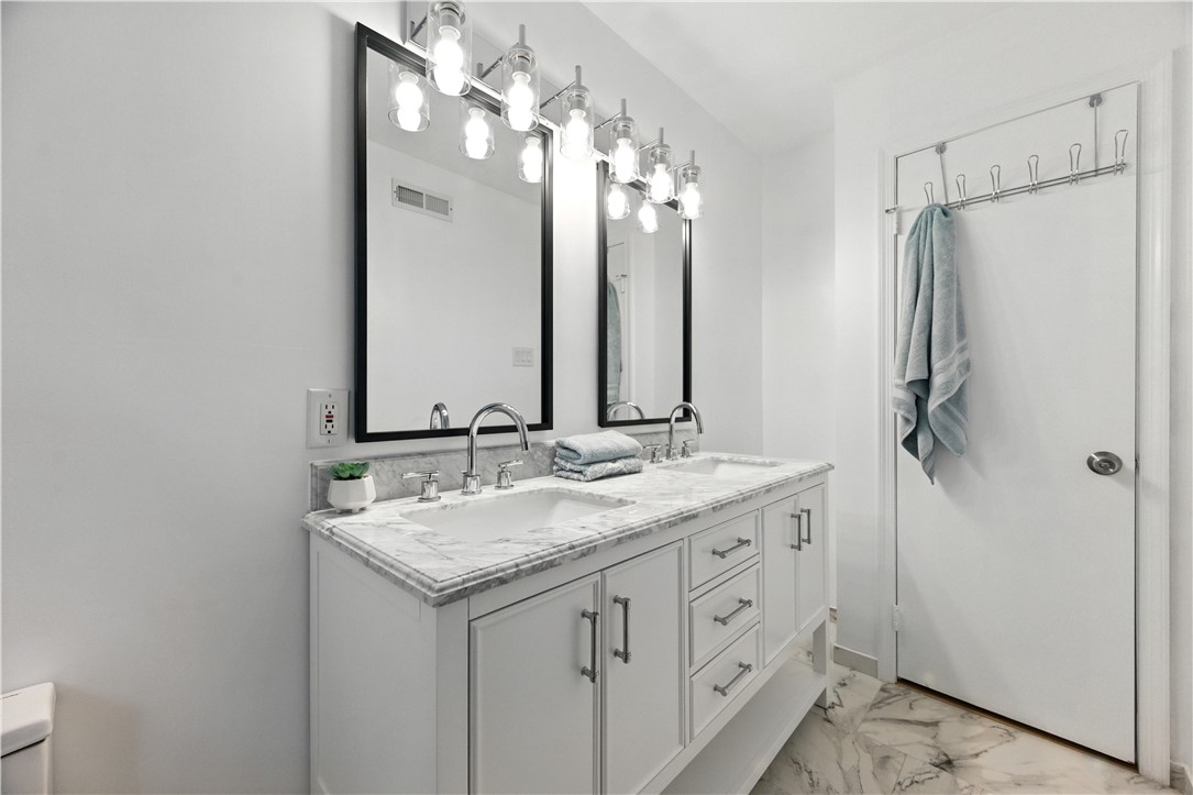 111 Braddock Road Williamsburg, VA 23185 - Photo 29 of 43 Bathroom featuring double vanity and light marble finish flooring