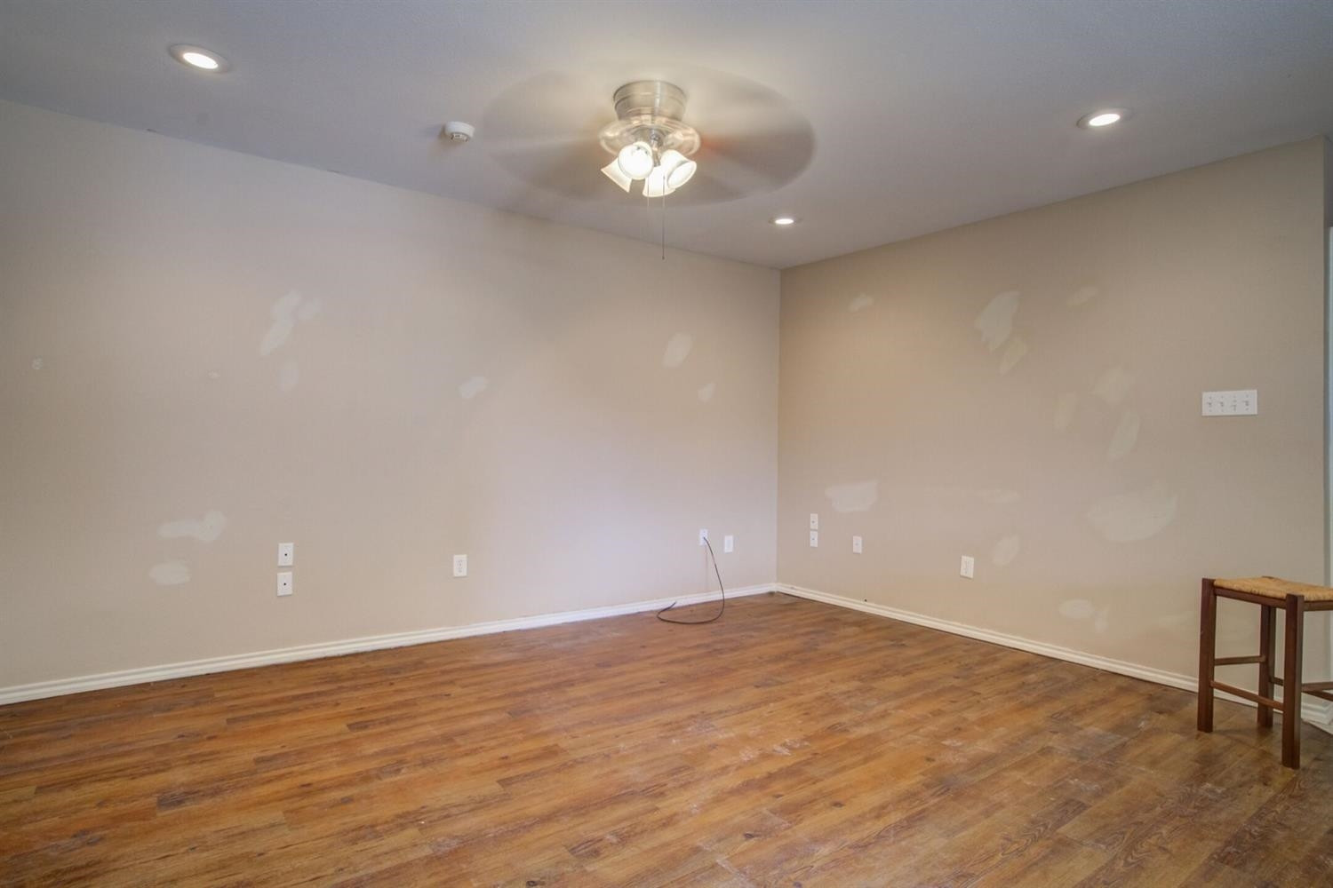 2601 33rd Street, Unit REAR Lubbock, TX 79410 - Photo 11 of 16 an empty room with wooden floor and a ceiling fan