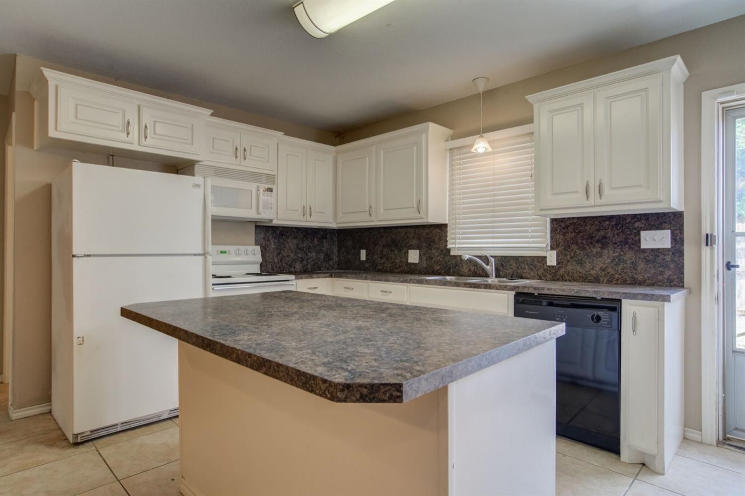 2601 33rd Street, Unit REAR Lubbock, TX 79410 - Photo 4 of 16 a kitchen with stainless steel appliances granite countertop a sink stove and refrigerator