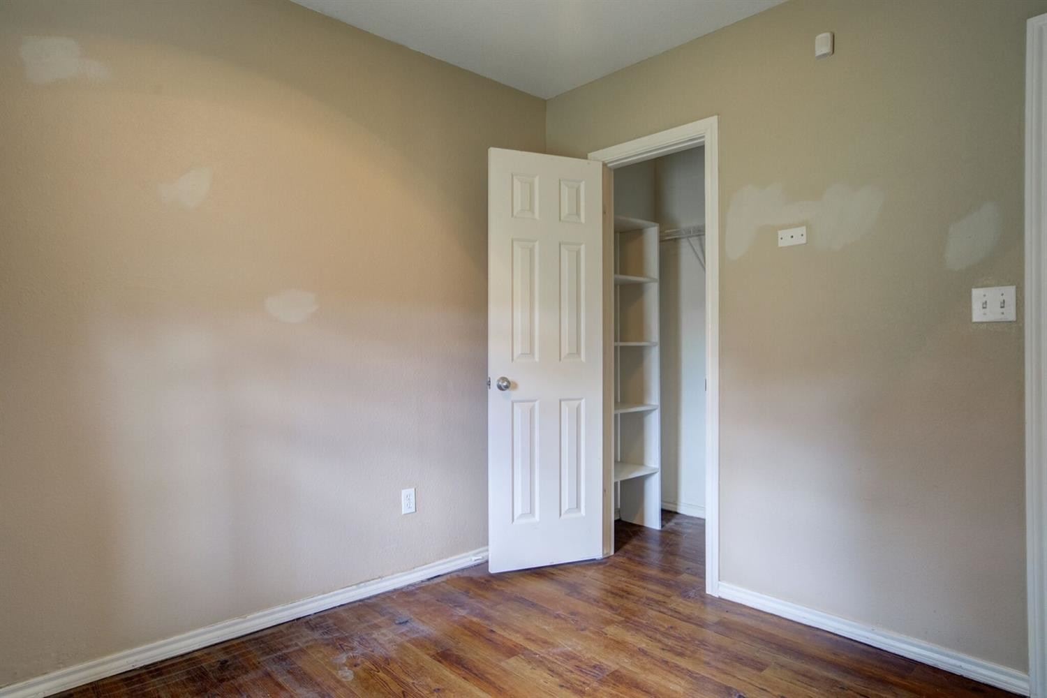 2601 33rd Street, Unit REAR Lubbock, TX 79410 - Photo 7 of 16 an empty room with wooden floor and entrance