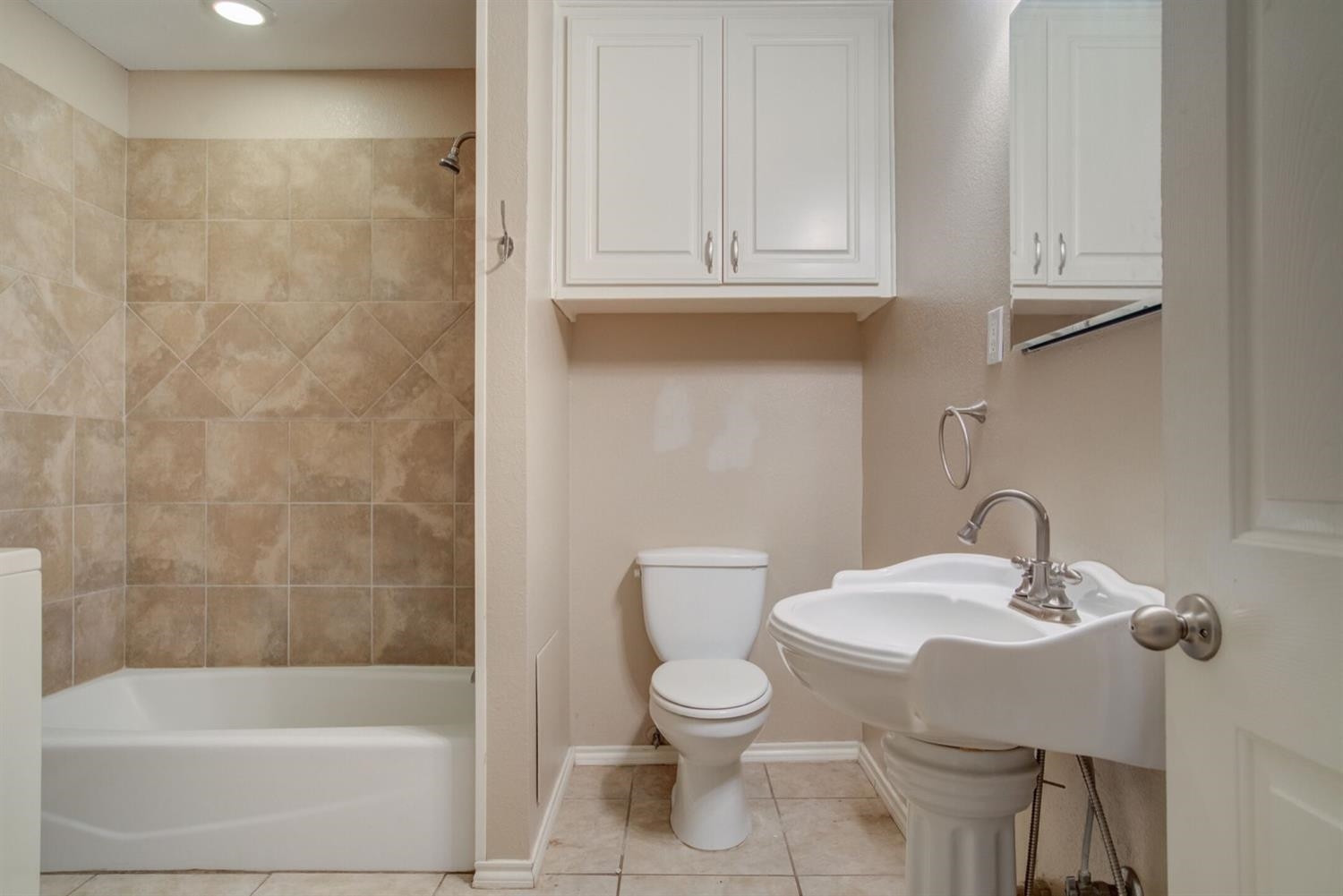2601 33rd Street, Unit REAR Lubbock, TX 79410 - Photo 9 of 16 a bathroom with a sink a toilet and bathtub