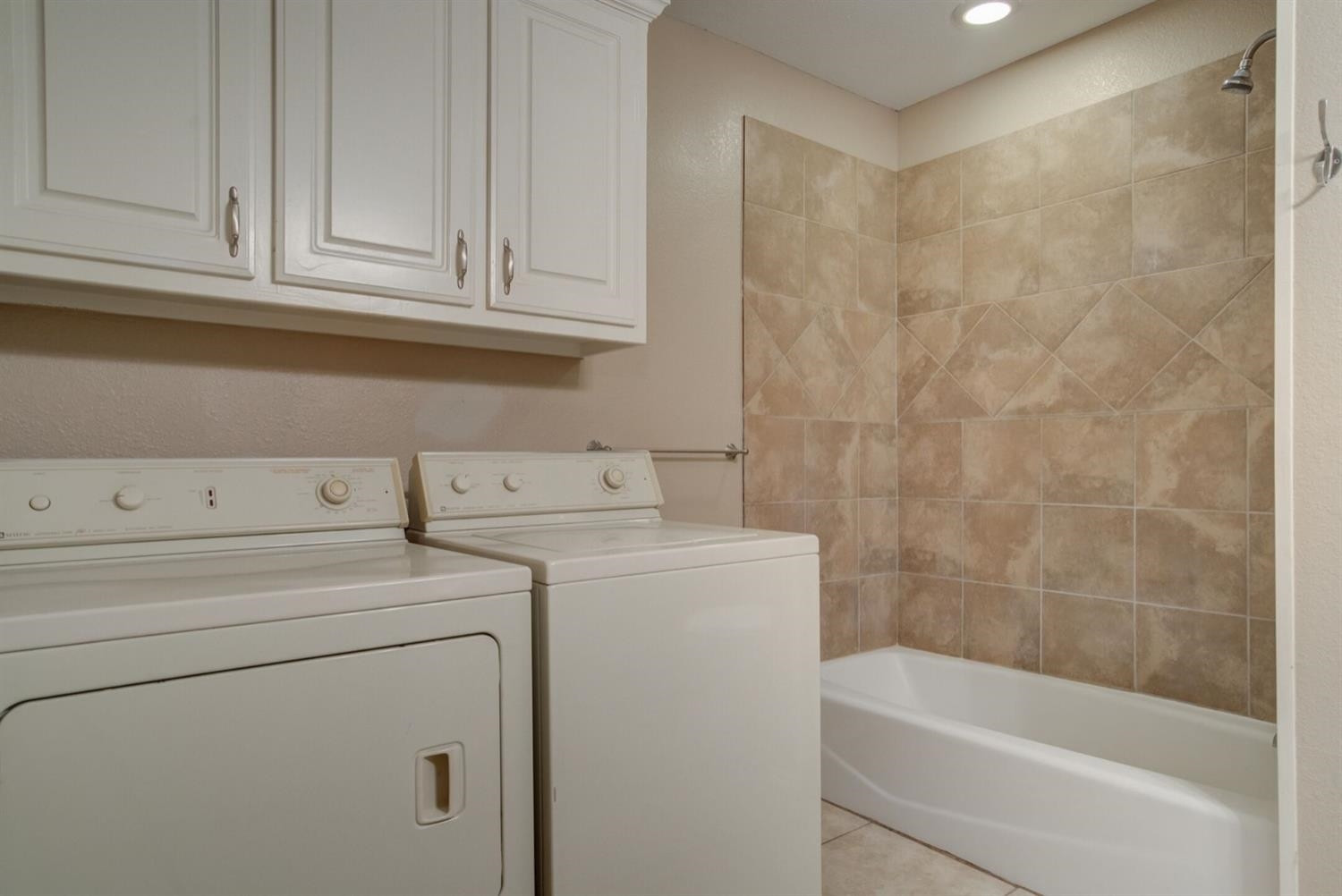 2601 33rd Street, Unit REAR Lubbock, TX 79410 - Photo 10 of 16 a bathroom with a sink a washer and dryer