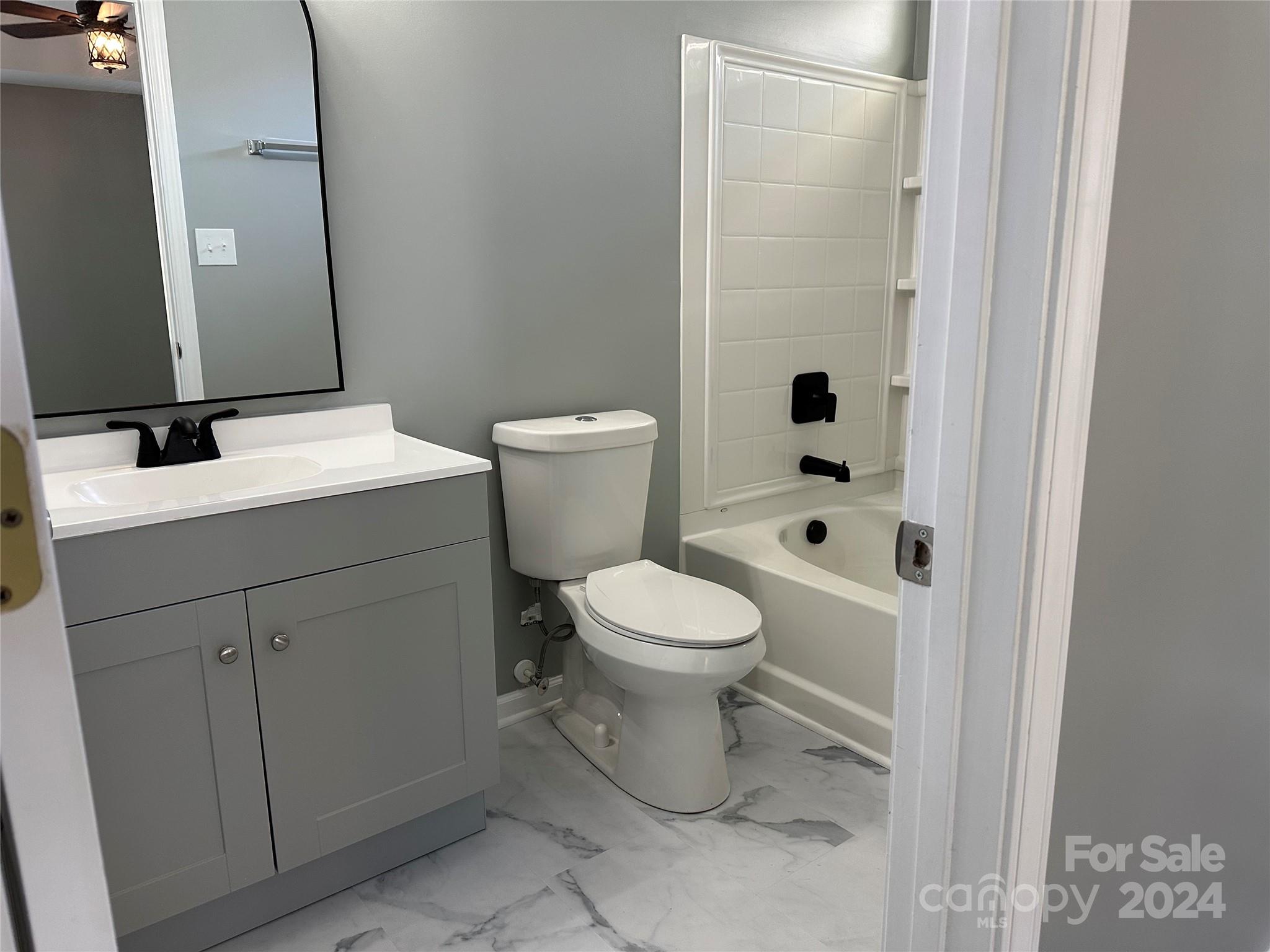 5131 Elizabeth Road Charlotte, NC 28269 - Photo 11 of 28 a bathroom with a sink a toilet and shower