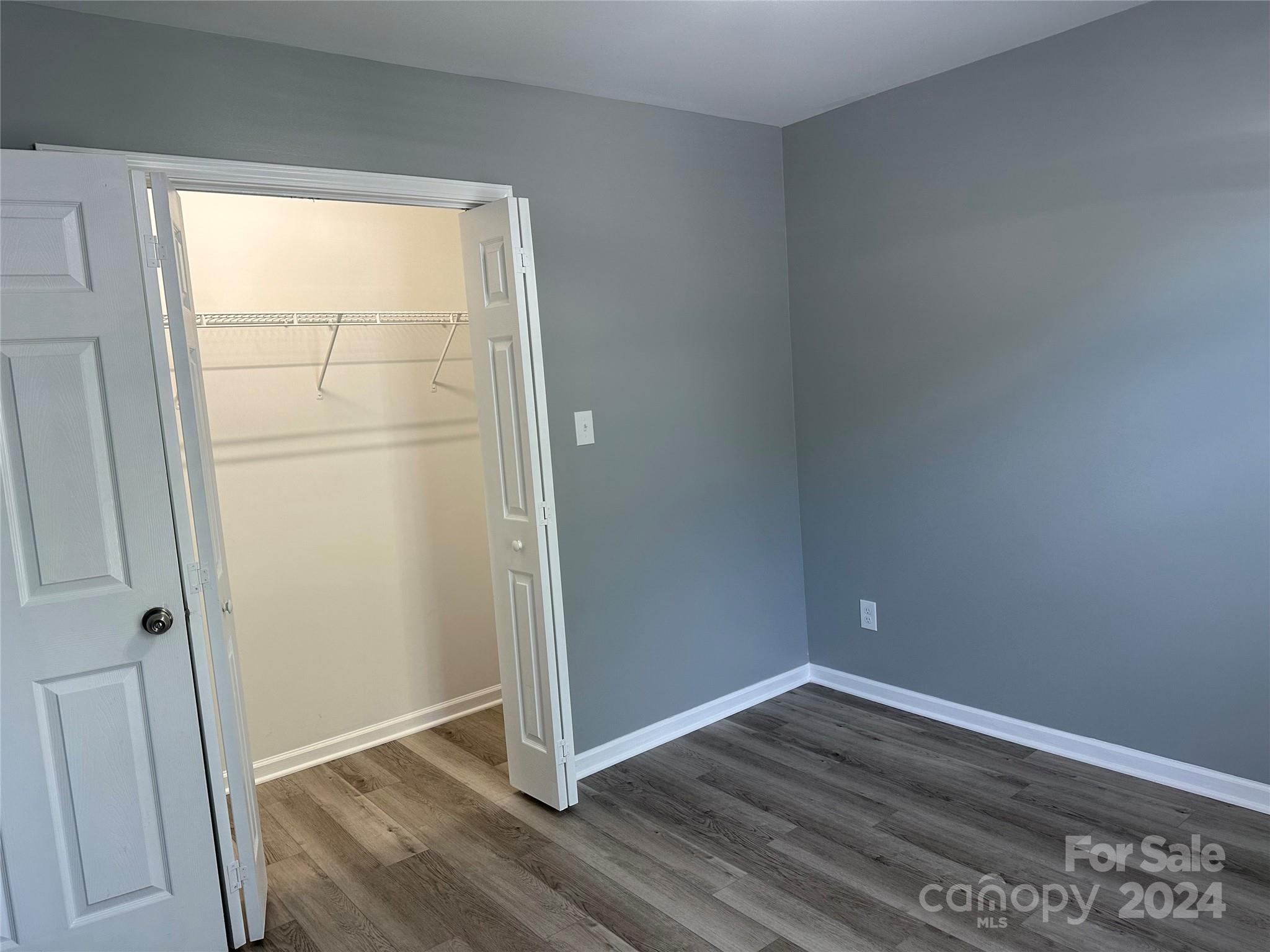 5131 Elizabeth Road Charlotte, NC 28269 - Photo 12 of 28 an empty room with wooden floor and a window
