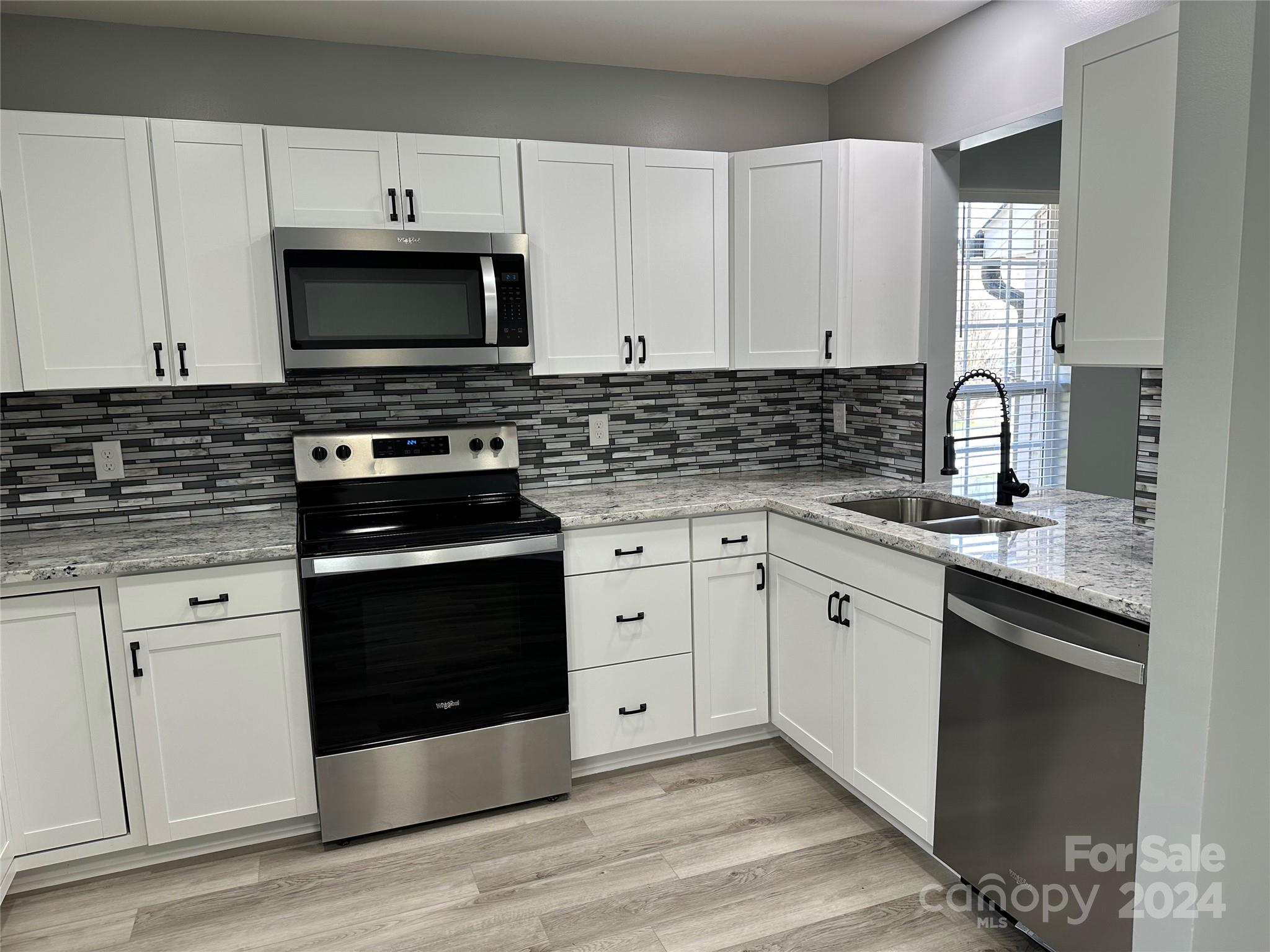 5131 Elizabeth Road Charlotte, NC 28269 - Photo 5 of 28 a kitchen with white cabinets and appliances