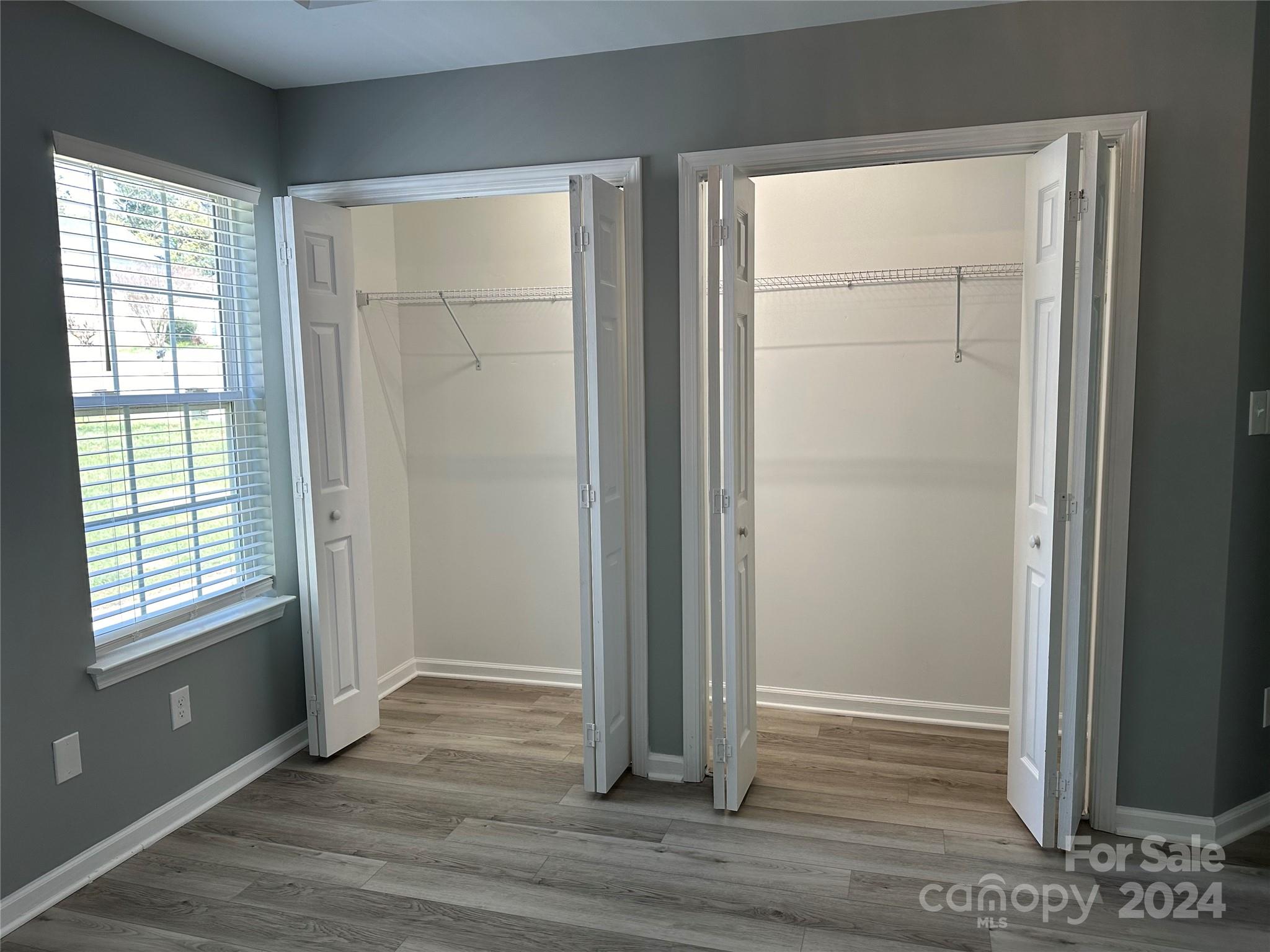 5131 Elizabeth Road Charlotte, NC 28269 - Photo 9 of 28 an empty room with wooden floor closet and windows