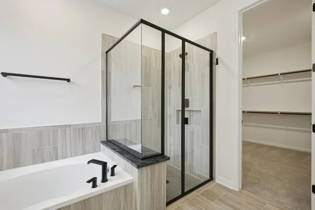 a bathroom with a shower and a tub