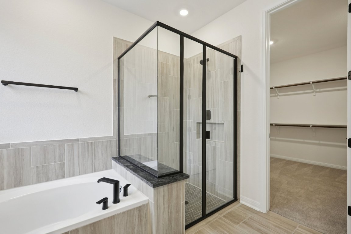 774 Jackson River Loop Kyle, TX 78640 - Photo 12 of 34 a bathroom with a shower and a tub