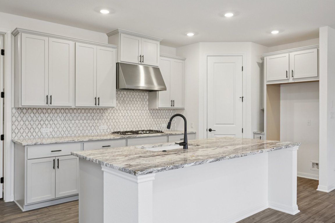 774 Jackson River Loop Kyle, TX 78640 - Photo 5 of 34 a kitchen with stainless steel appliances granite countertop a sink stove and refrigerator