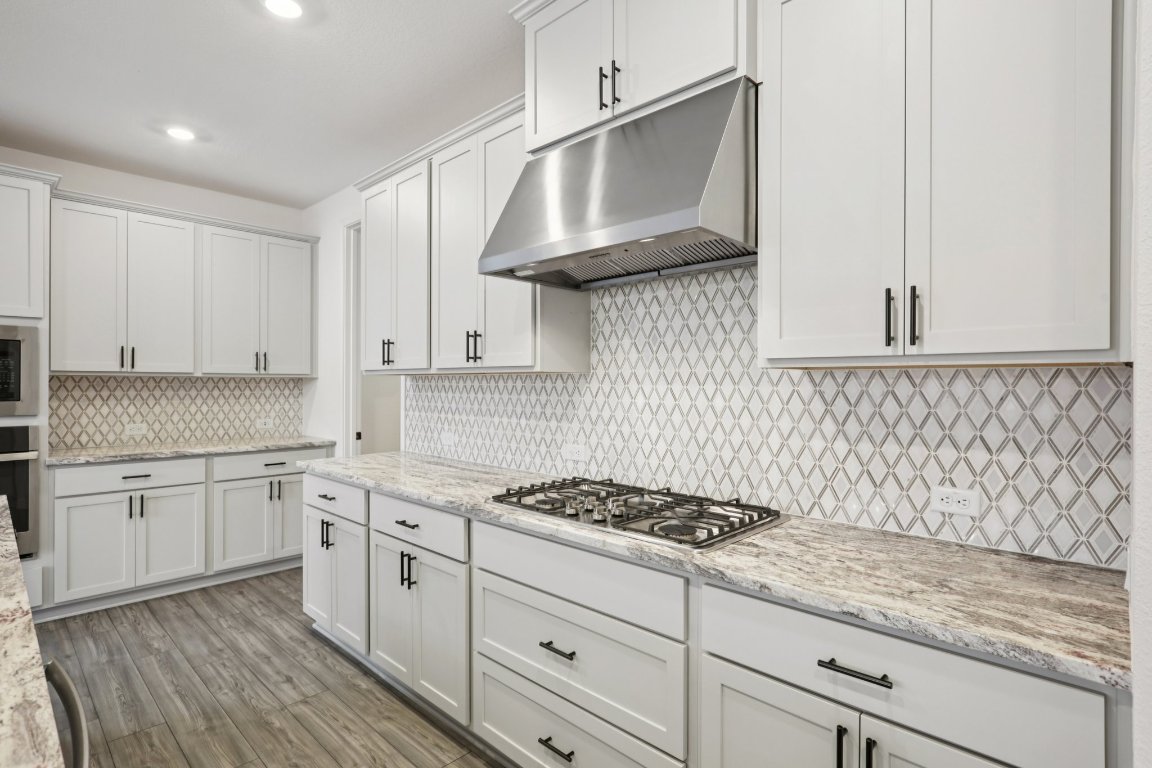 774 Jackson River Loop Kyle, TX 78640 - Photo 6 of 34 a kitchen with stainless steel appliances granite countertop white cabinets a sink and dishwasher