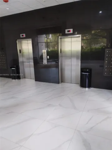 a kitchen with granite countertop a refrigerator and a counter top
