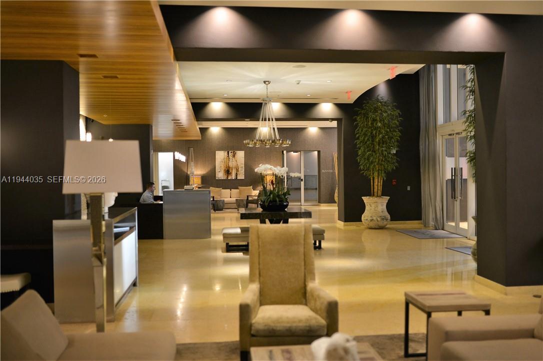 60 Southwest 13th Street, Unit 3015 Miami, FL 33130 - Photo 11 of 14 a living room with furniture and a fireplace