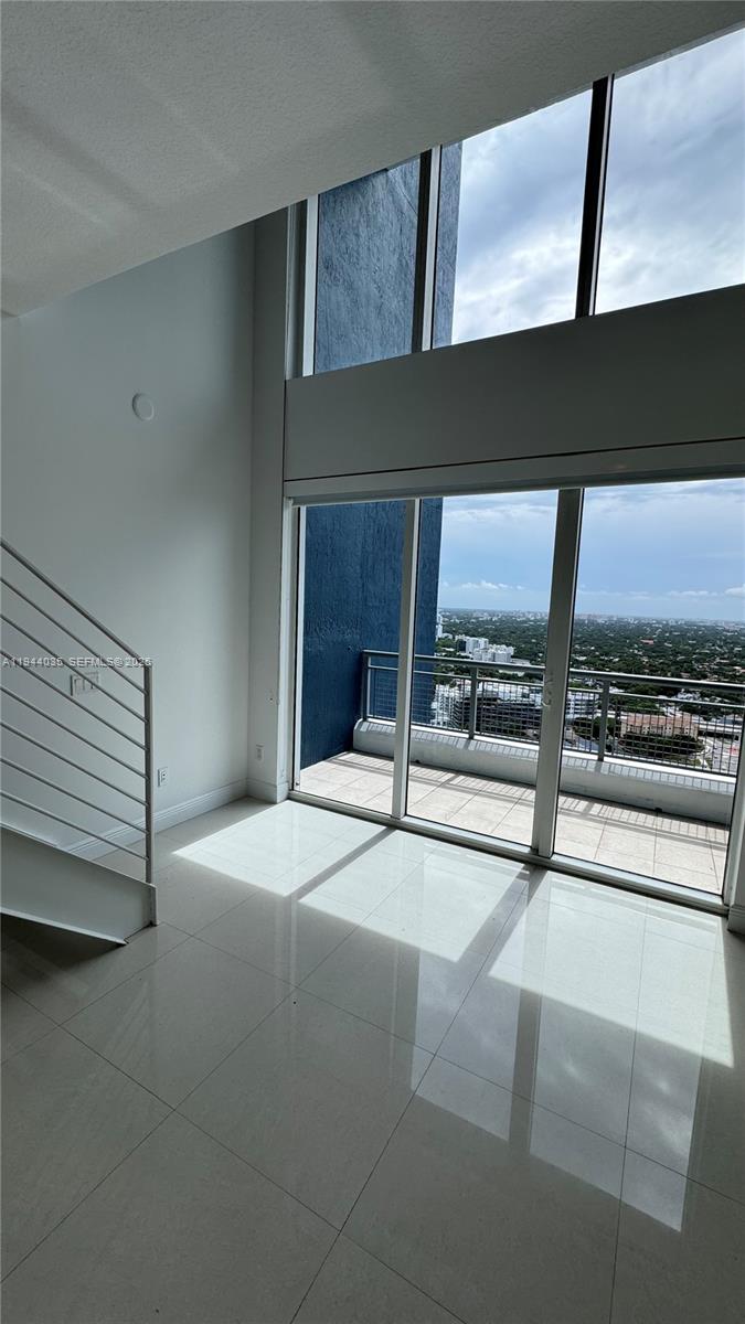 60 Southwest 13th Street, Unit 3015 Miami, FL 33130 - Photo 5 of 14 a bedroom with a bed and large window