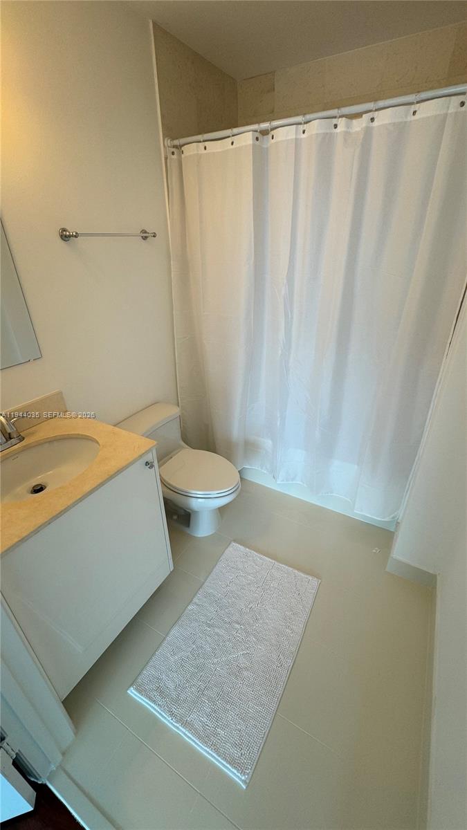 60 Southwest 13th Street, Unit 3015 Miami, FL 33130 - Photo 8 of 14 a bathroom with a sink a toilet and shower