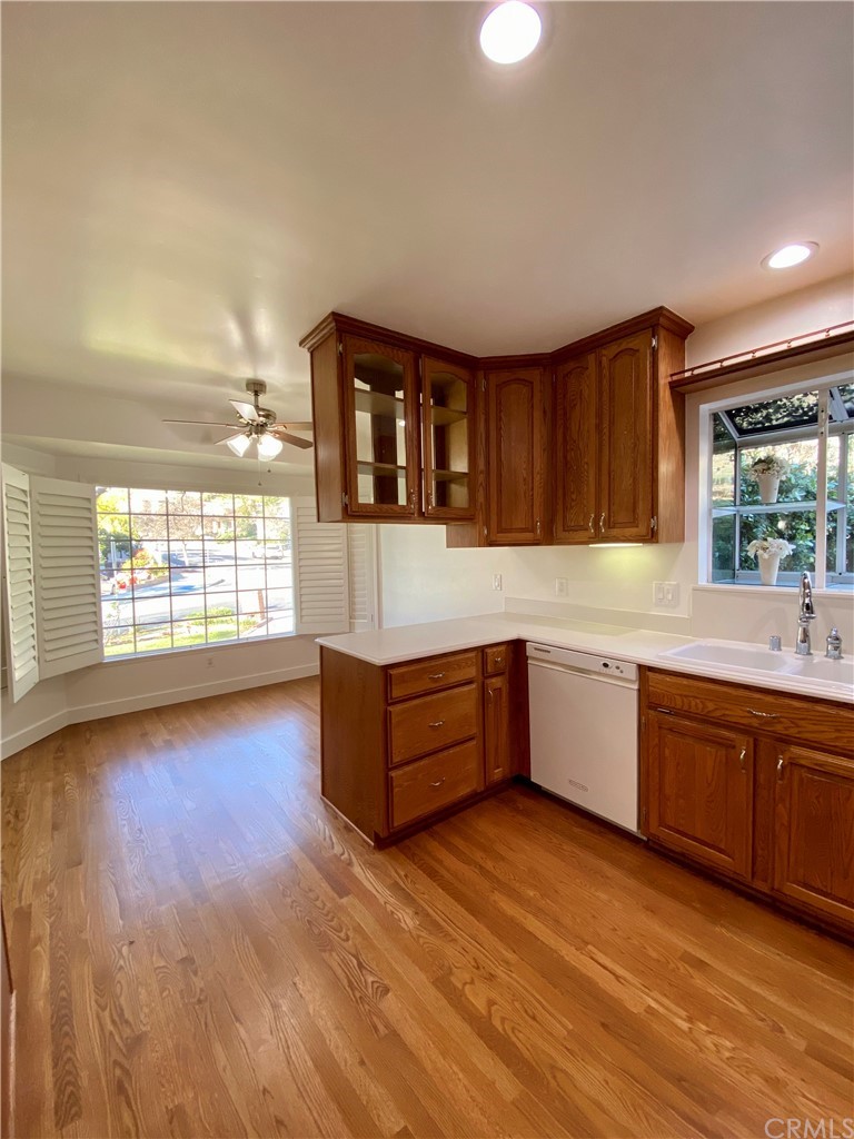 948 Cambridge Drive Burbank, CA 91504 - Photo 11 of 36 a kitchen with stainless steel appliances granite countertop a stove a sink wooden cabinets and a large window