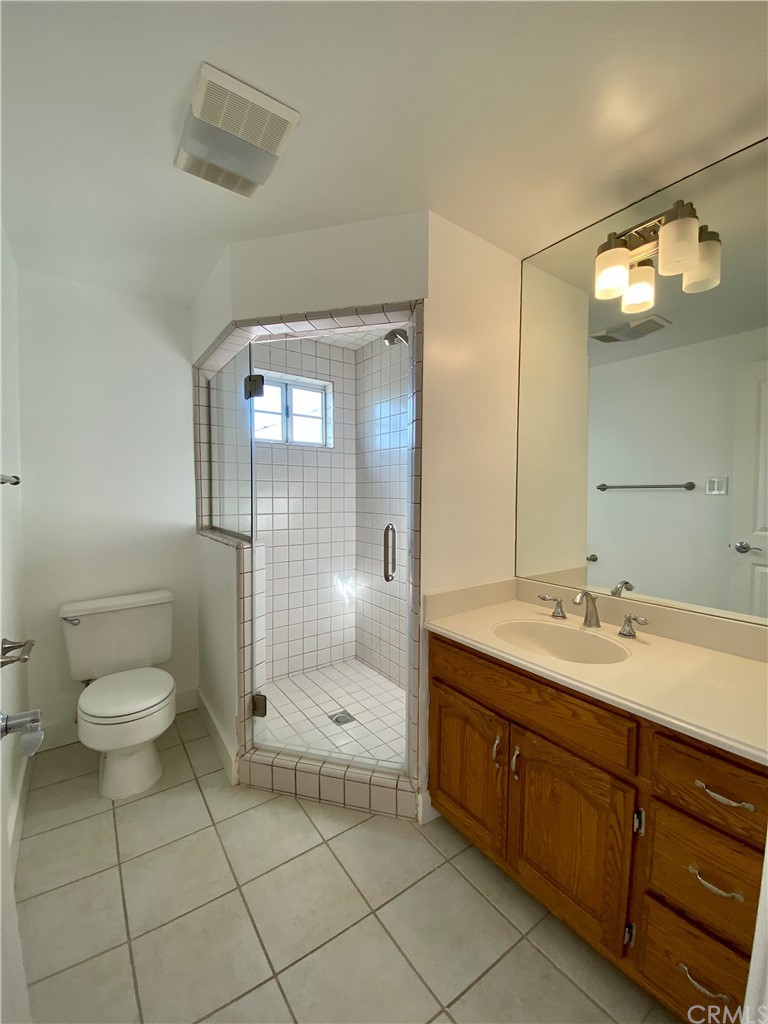 948 Cambridge Drive Burbank, CA 91504 - Photo 20 of 36 a spacious bathroom with a double vanity sink toilet and a shower