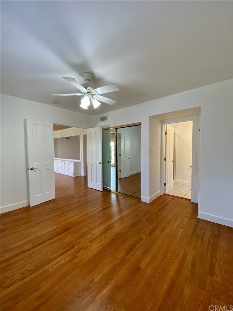 948 Cambridge Drive Burbank, CA 91504 - Photo 26 of 36 a view of an empty room with wooden floor and a ceiling fan