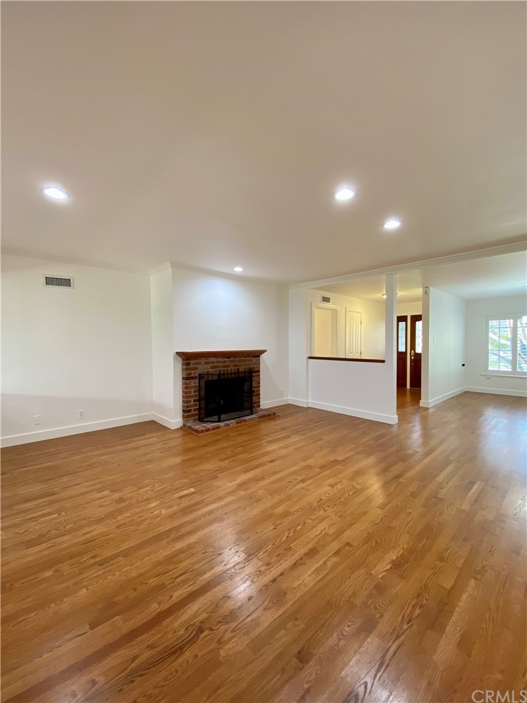 948 Cambridge Drive Burbank, CA 91504 - Photo 6 of 36 a view of empty room with wooden floor and windows