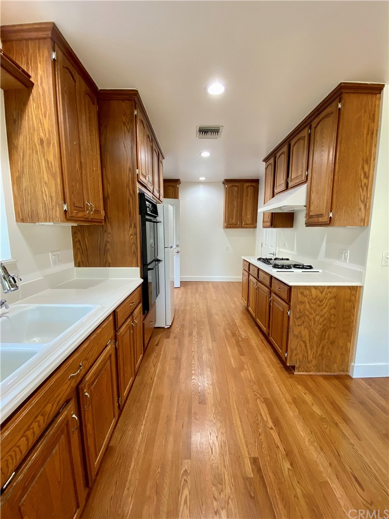 948 Cambridge Drive Burbank, CA 91504 - Photo 8 of 36 a kitchen with stainless steel appliances granite countertop a stove a sink and a refrigerator