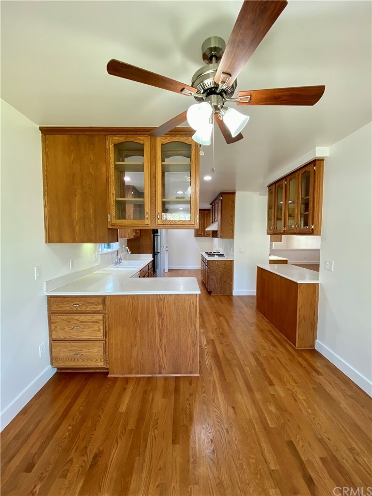 948 Cambridge Drive Burbank, CA 91504 - Photo 10 of 36 a kitchen with stainless steel appliances granite countertop a sink cabinets and wooden floor