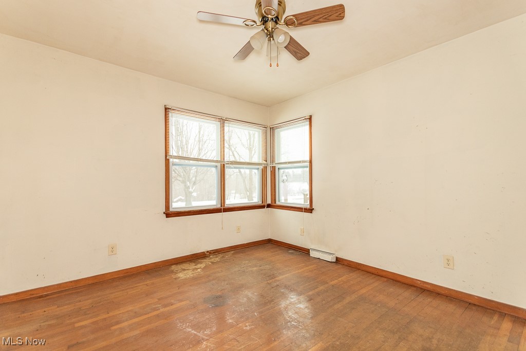 3303 River Road Perry, OH 44081 - Photo 17 of 34 Empty room with wood-type flooring and ceiling fan