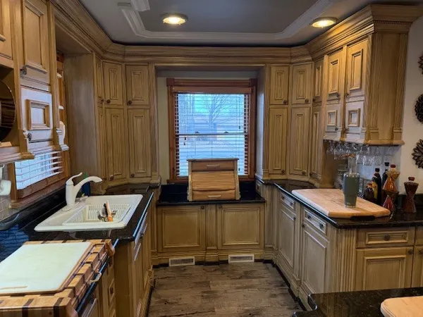 a kitchen with granite countertop a sink and cabinets
