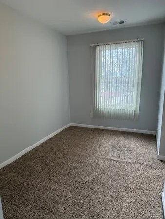 a view of a house with a large window and a garage