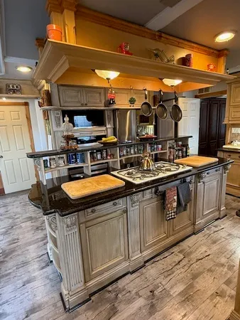 a kitchen with stainless steel appliances granite countertop a stove and a refrigerator