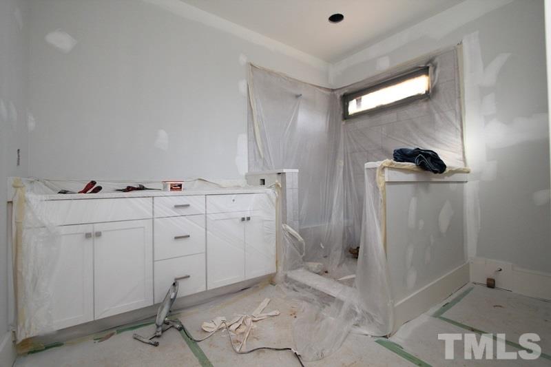707 South State Street Raleigh, NC 27601 - Photo 16 of 23 a room with white cabinets and window