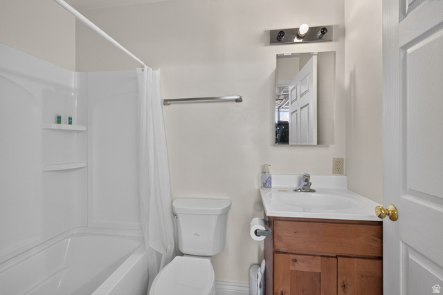 4635 East Sunny Acres Lane Moab, UT 84532 - Photo 39 of 56 Bathroom featuring a white tub and shower combination with integrated shelving, a white toilet, and a wood-finish vanity with a single basin sink